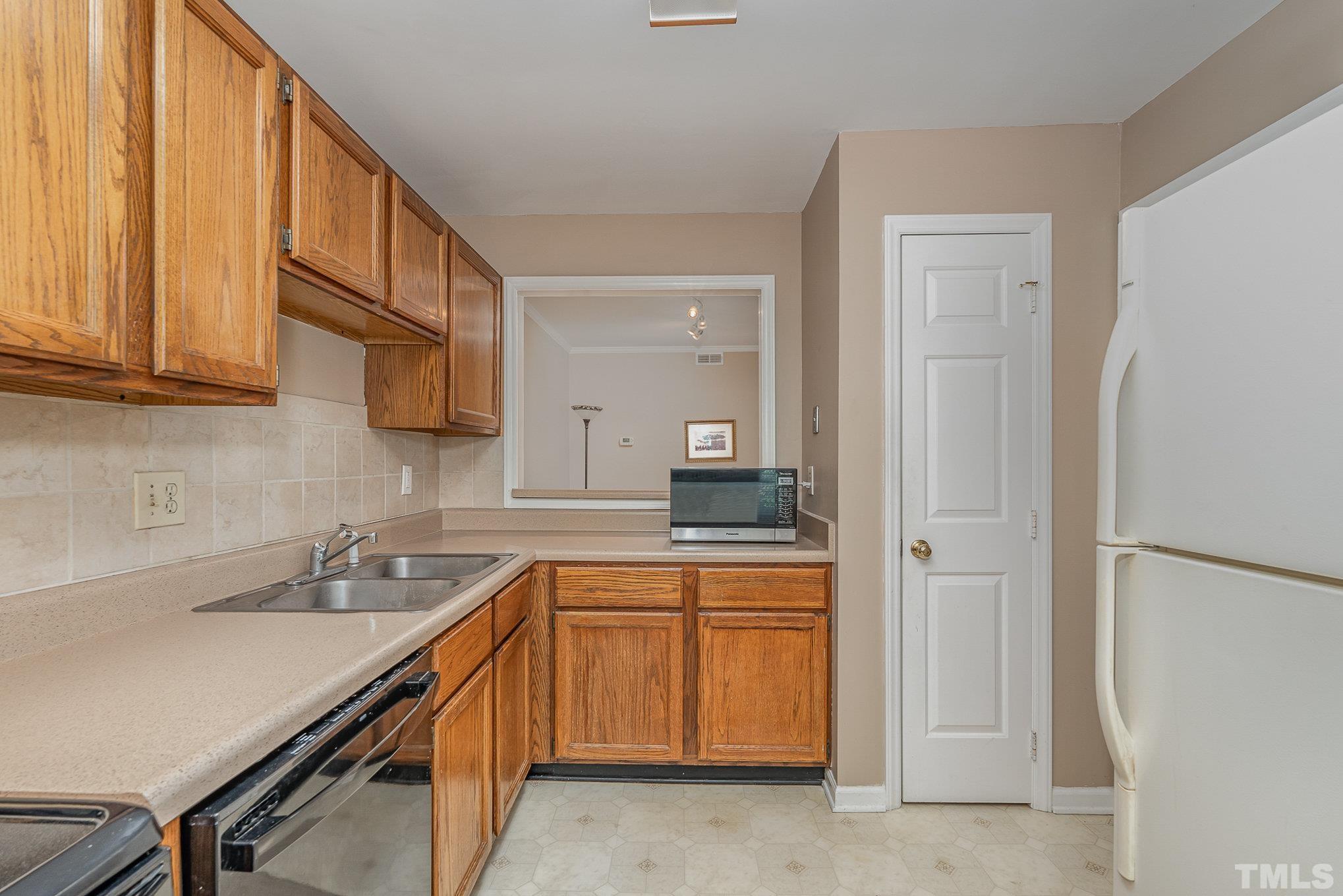 101 Autumn Chase Drive Raleigh, NC 27613 - Photo 9 of 18 a kitchen with a sink and cabinets