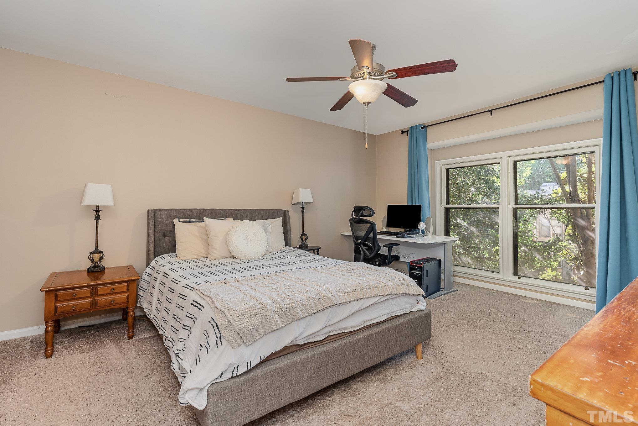 101 Autumn Chase Drive Raleigh, NC 27613 - Photo 10 of 18 a bedroom with a large bed and a large window