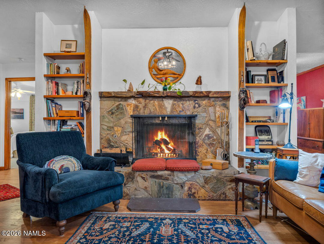 1005 Park Way Williams, AZ 86046 - Photo 11 of 45 a living room with furniture a fireplace and a bookshelf