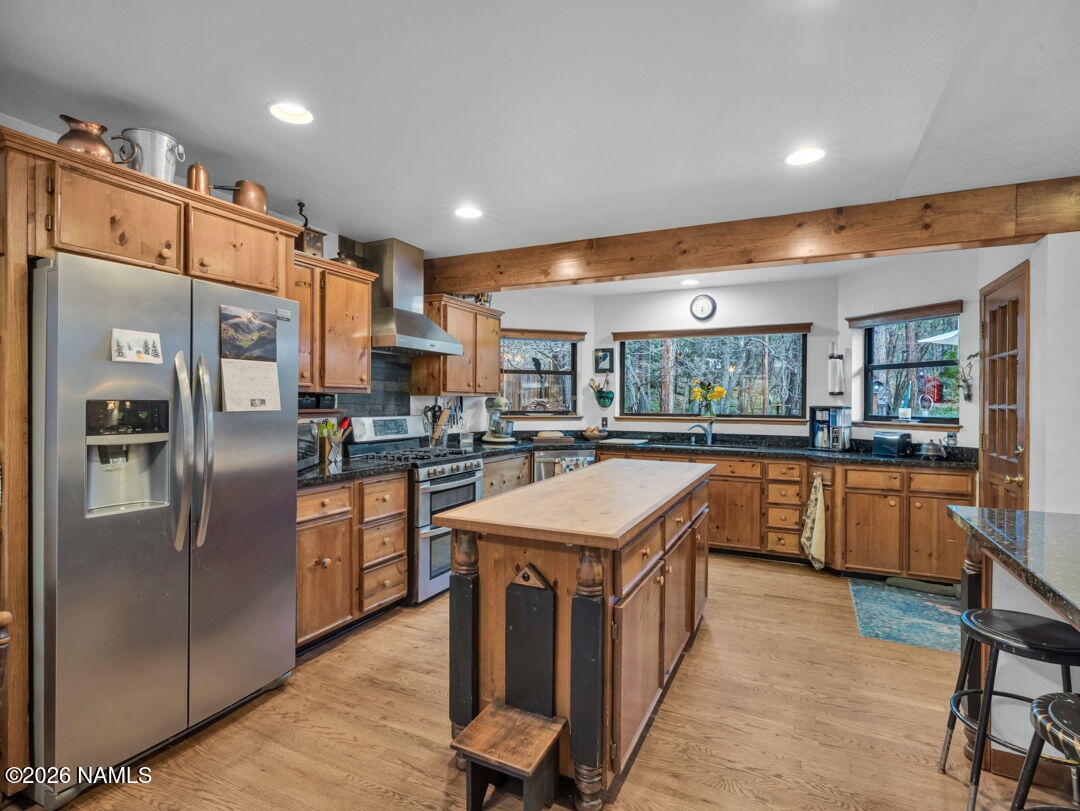 1005 Park Way Williams, AZ 86046 - Photo 13 of 45 a kitchen with stainless steel appliances granite countertop a refrigerator a sink dishwasher and a stove with wooden floor
