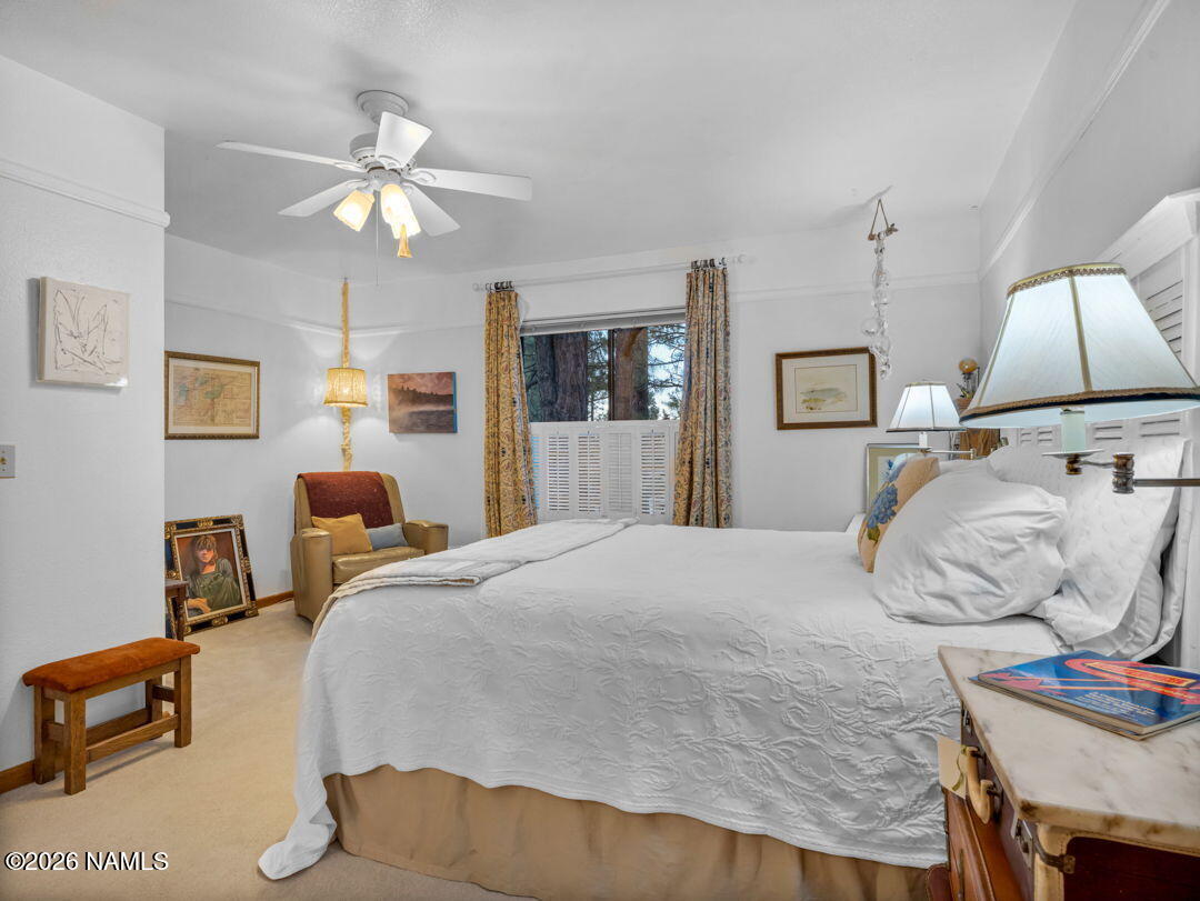 1005 Park Way Williams, AZ 86046 - Photo 19 of 45 a bedroom with a bed and a chandelier