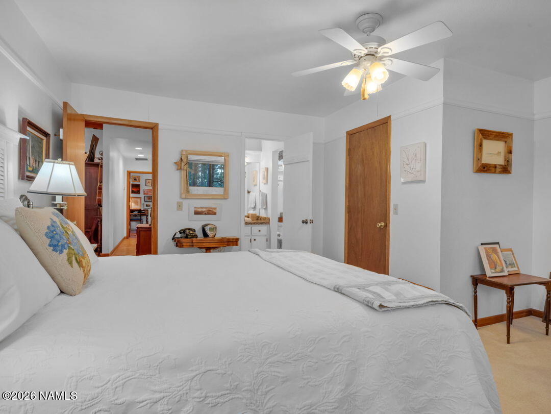 1005 Park Way Williams, AZ 86046 - Photo 20 of 45 a bedroom with a bed and a chandelier