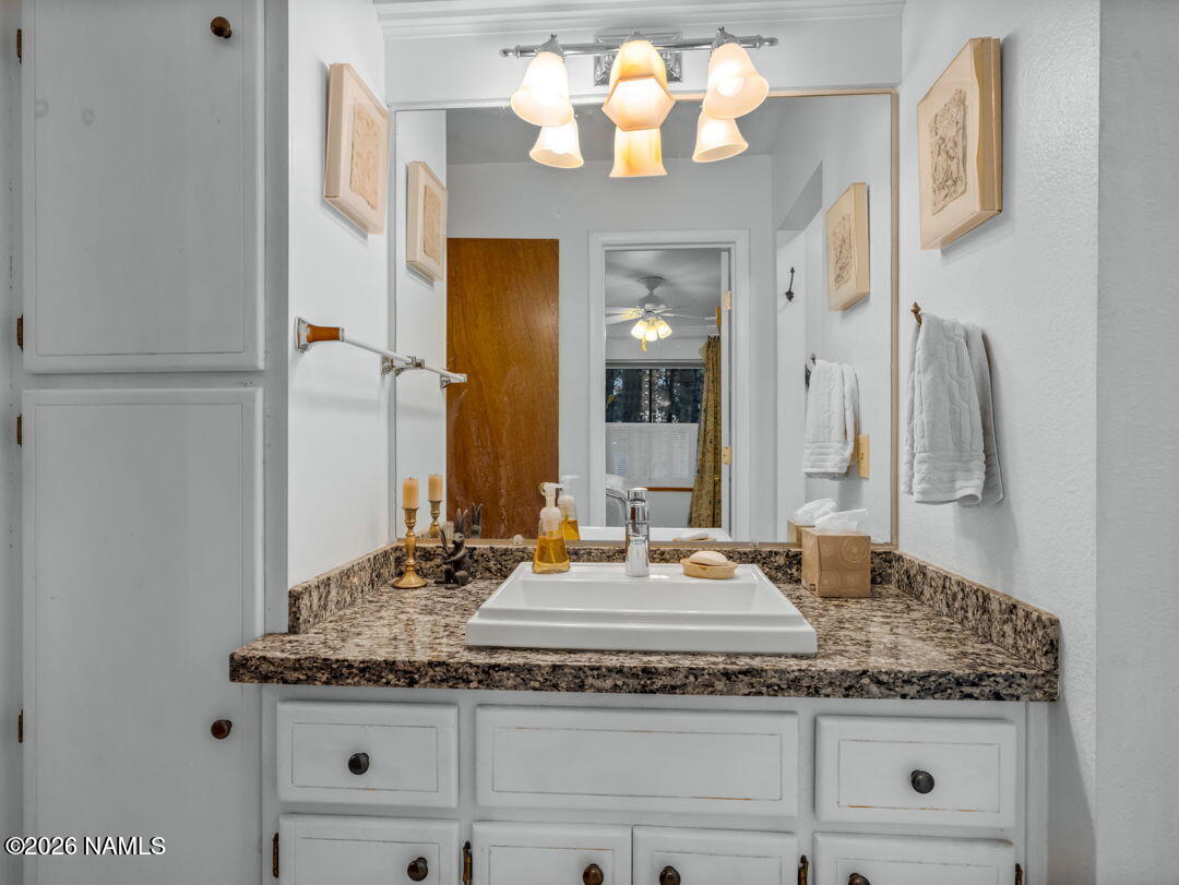 1005 Park Way Williams, AZ 86046 - Photo 21 of 45 a bathroom with a granite countertop sink and a mirror