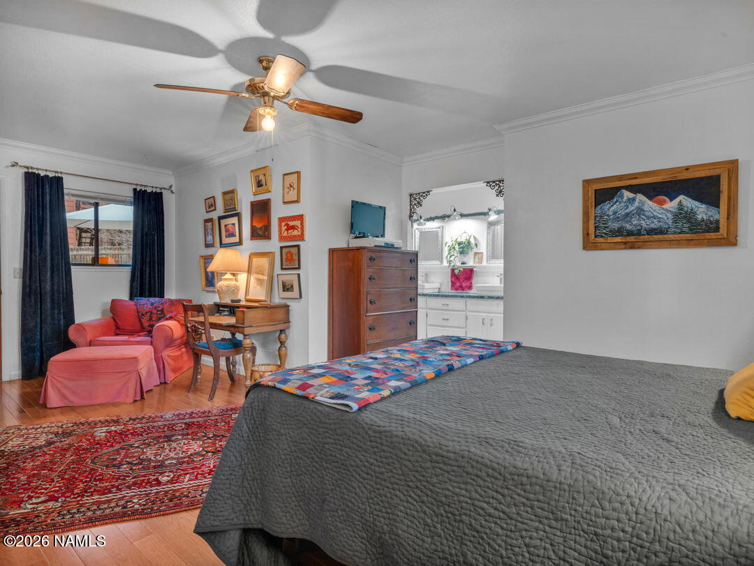 1005 Park Way Williams, AZ 86046 - Photo 26 of 45 a bedroom with a bed and a chandelier