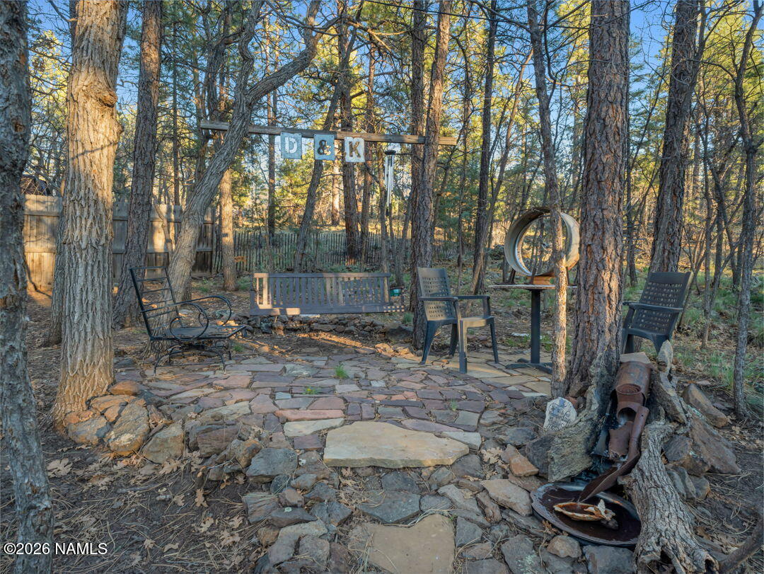 1005 Park Way Williams, AZ 86046 - Photo 35 of 45 a backyard of a house with lots of green space and glass windows