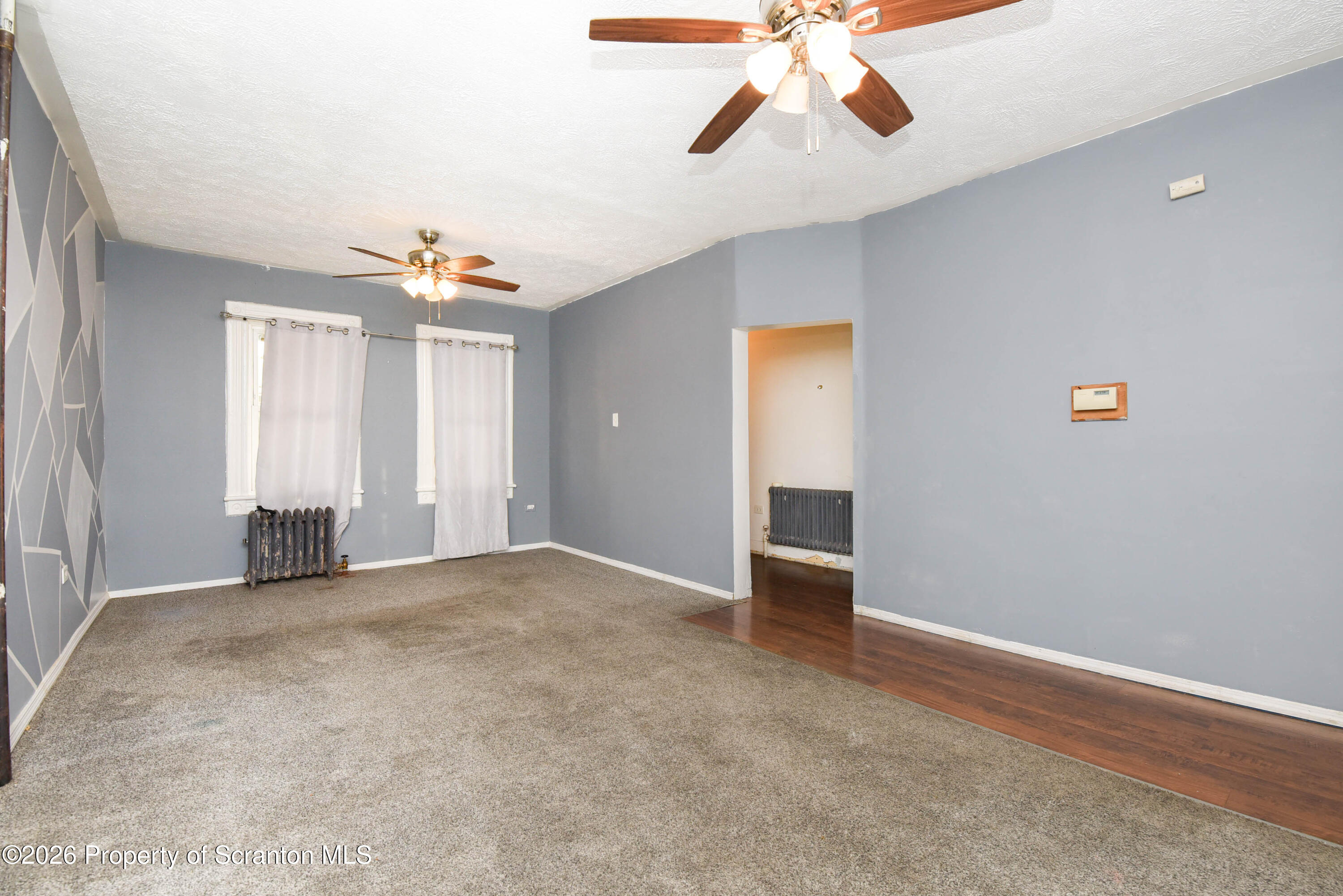 2 Ferguson Place Dunmore, PA 18509 - Photo 8 of 33 an empty room with chandelier fan and windows