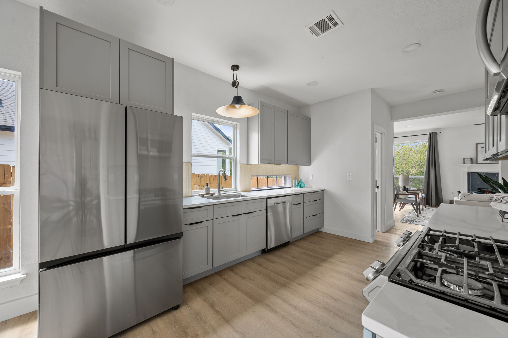 11604 Loweswater Lane Austin, TX 78754 - Photo 12 of 34 a kitchen with a sink stove and refrigerator