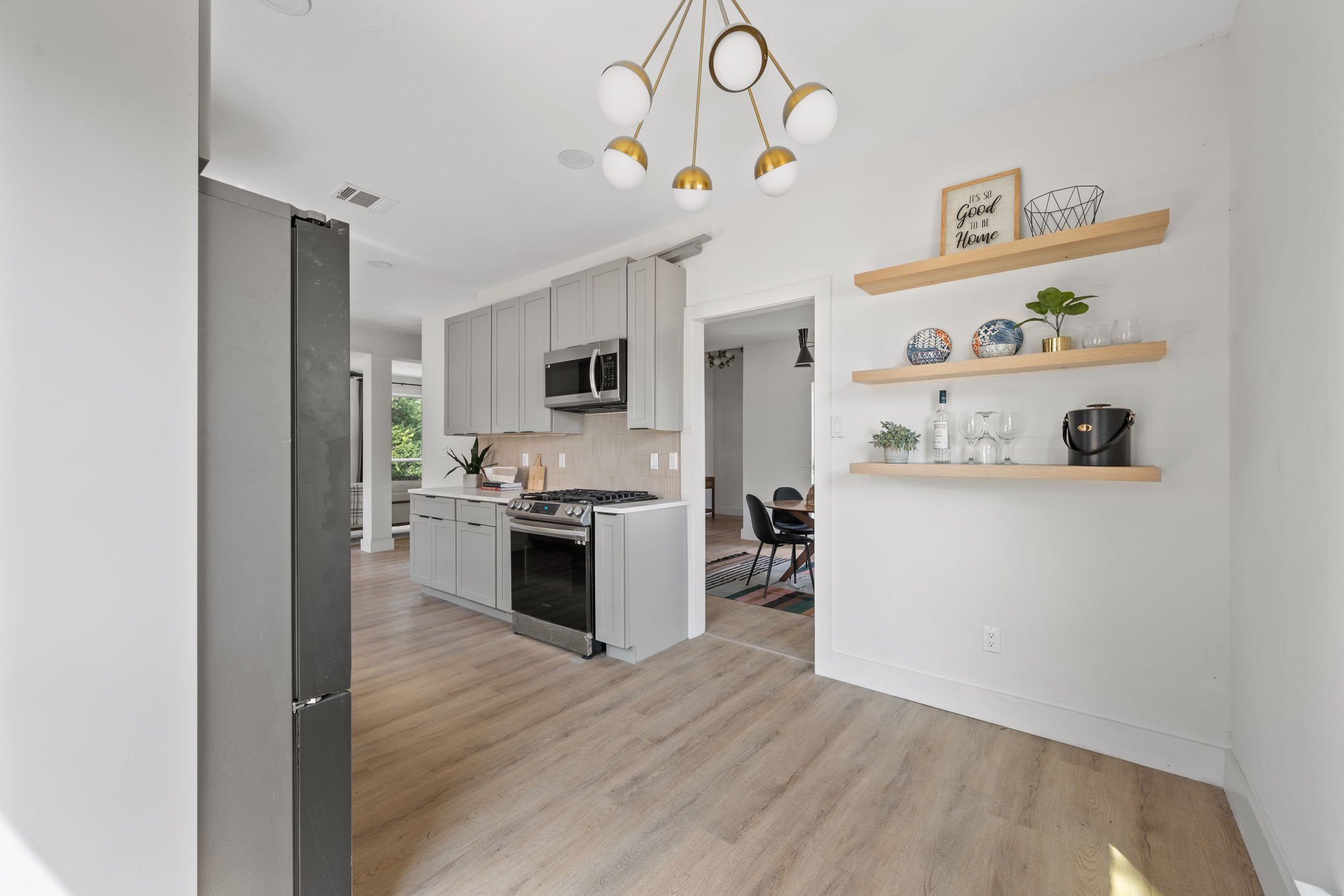 11604 Loweswater Lane Austin, TX 78754 - Photo 13 of 34 a kitchen with a refrigerator cabinets and wooden floor