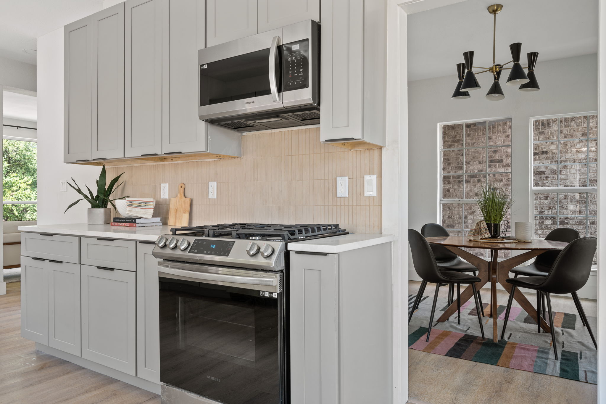 11604 Loweswater Lane Austin, TX 78754 - Photo 14 of 34 a kitchen with stainless steel appliances a stove a microwave and cabinets