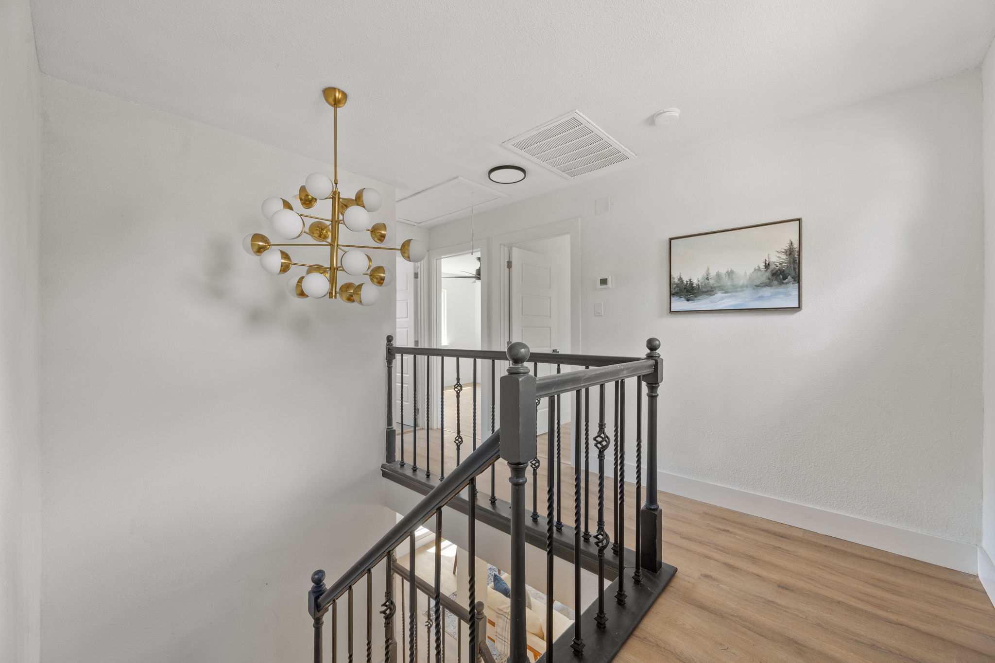 11604 Loweswater Lane Austin, TX 78754 - Photo 17 of 34 a view of a hallway with wooden floor and chandelier