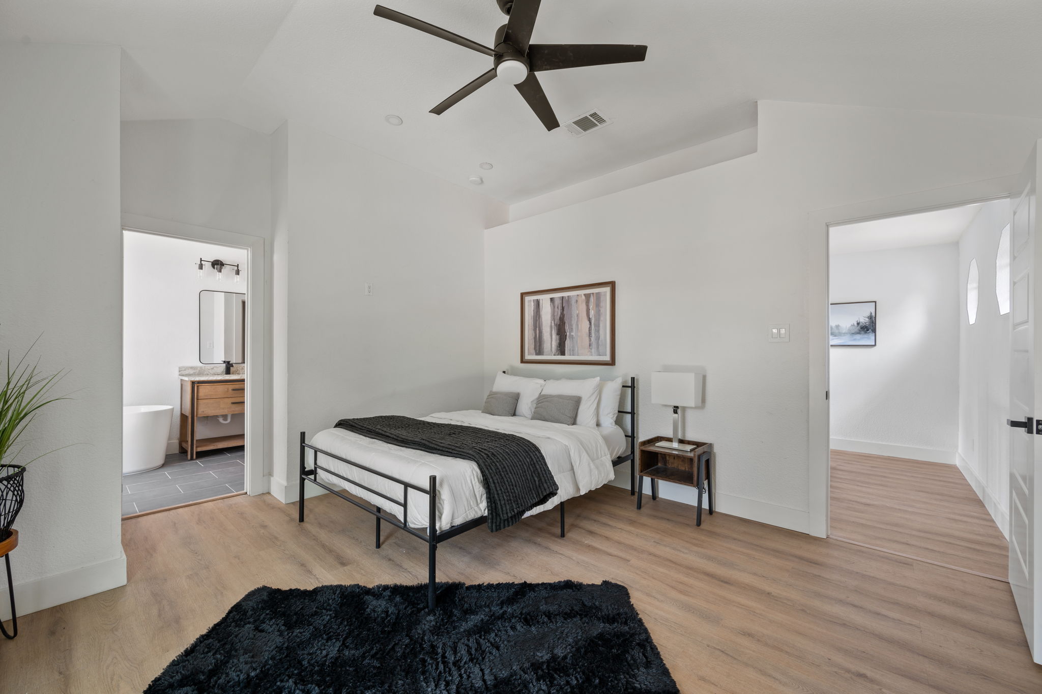 11604 Loweswater Lane Austin, TX 78754 - Photo 19 of 34 a bedroom with a bed and wooden floor