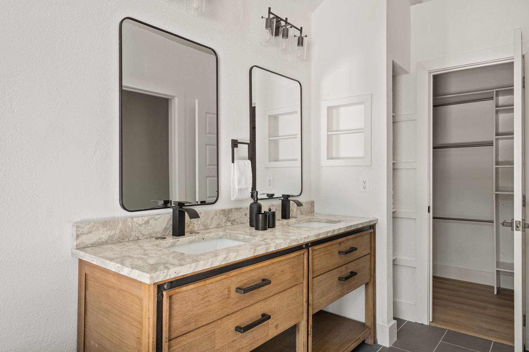 11604 Loweswater Lane Austin, TX 78754 - Photo 20 of 34 a bathroom with a granite countertop sink and a mirror