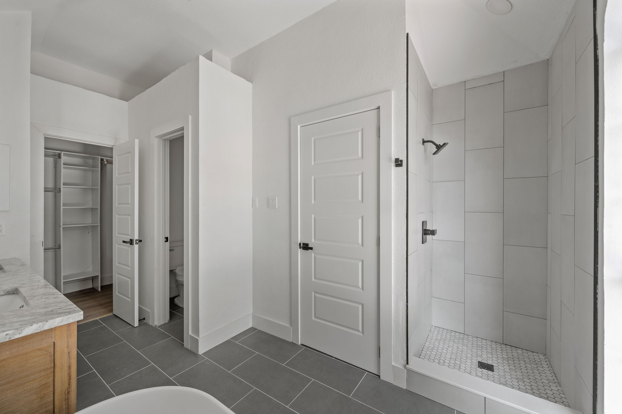 11604 Loweswater Lane Austin, TX 78754 - Photo 22 of 34 a spacious bathroom with a glass door shower