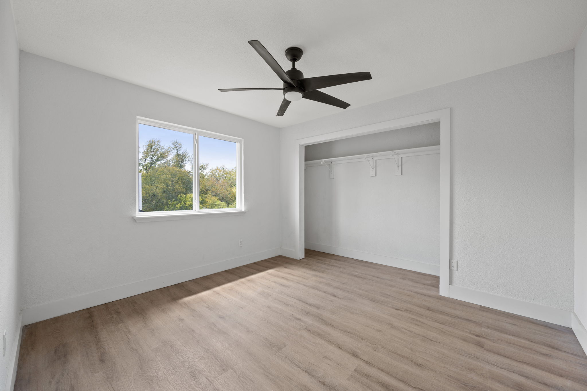 11604 Loweswater Lane Austin, TX 78754 - Photo 24 of 34 a view of empty room with wooden floor and ceiling fan