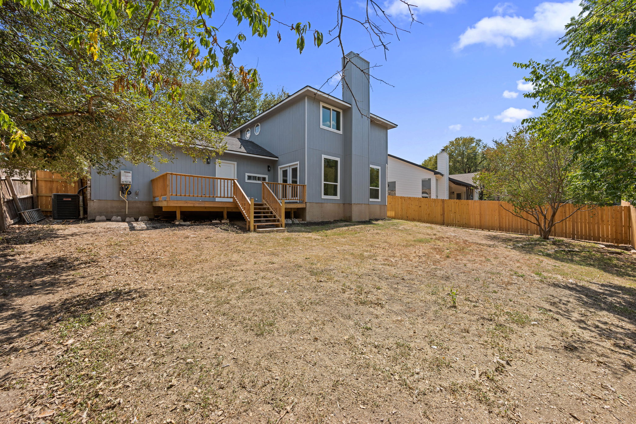 11604 Loweswater Lane Austin, TX 78754 - Photo 29 of 34 a front view of a house with a yard covered with snow and trees