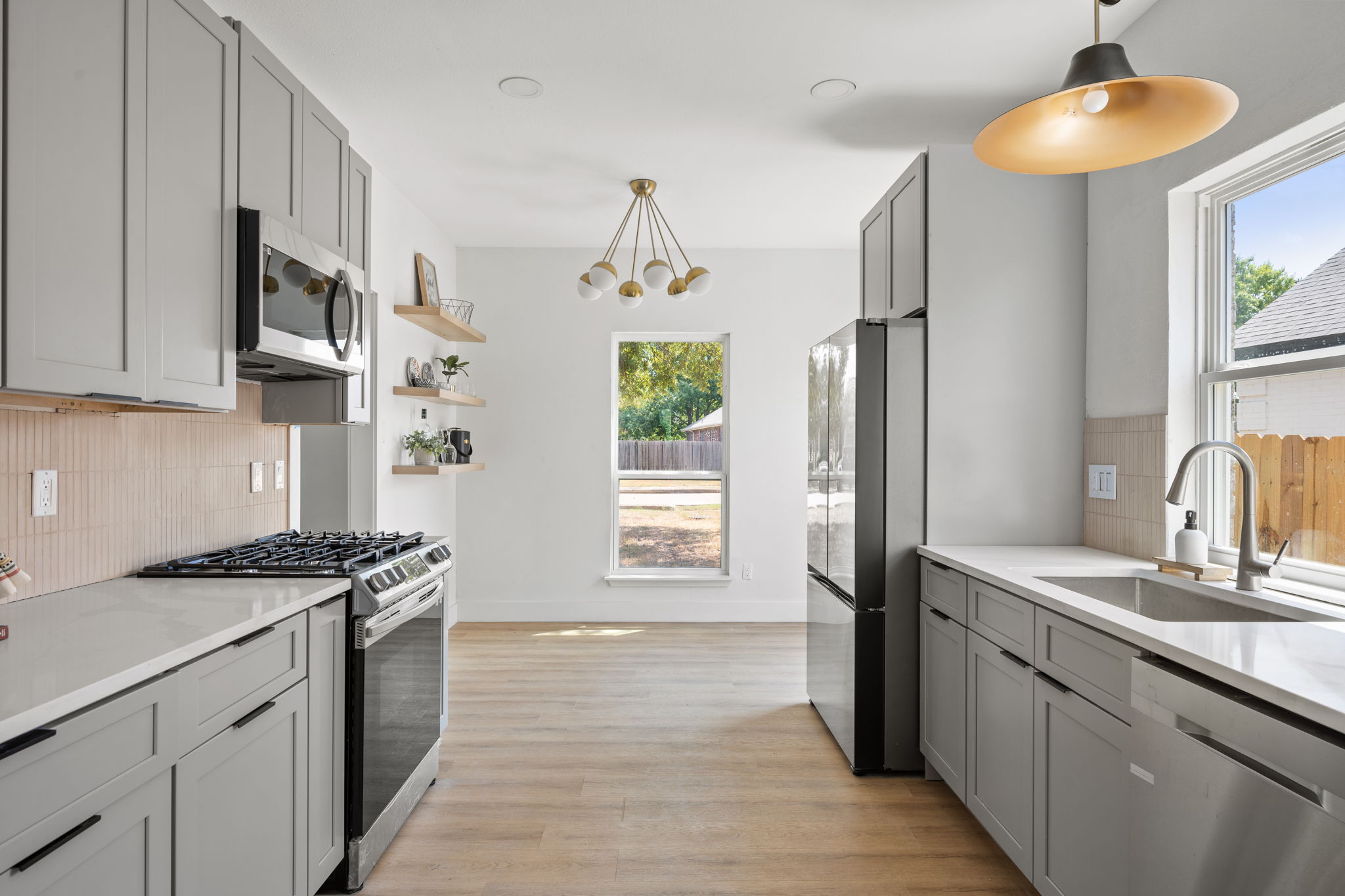 11604 Loweswater Lane Austin, TX 78754 - Photo 8 of 34 a kitchen with stainless steel appliances granite countertop a sink a stove a refrigerator cabinets and a window