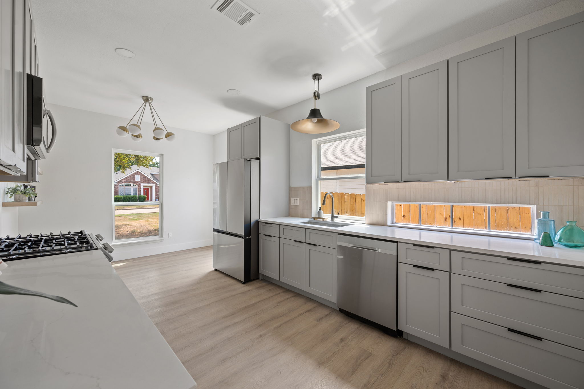 11604 Loweswater Lane Austin, TX 78754 - Photo 9 of 34 a kitchen with stainless steel appliances granite countertop a sink and a stove top oven
