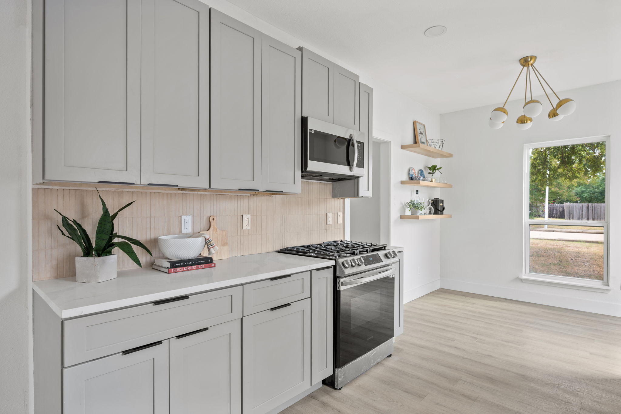 11604 Loweswater Lane Austin, TX 78754 - Photo 10 of 34 a kitchen with stainless steel appliances granite countertop a stove a sink and a white cabinets