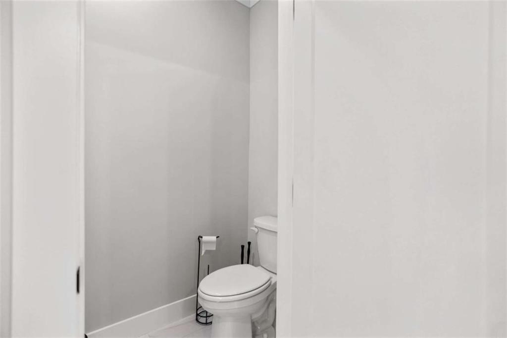 4466 Lemon Street Acworth, GA 30101 - Photo 49 of 65 a white toilet sitting next to a white wall