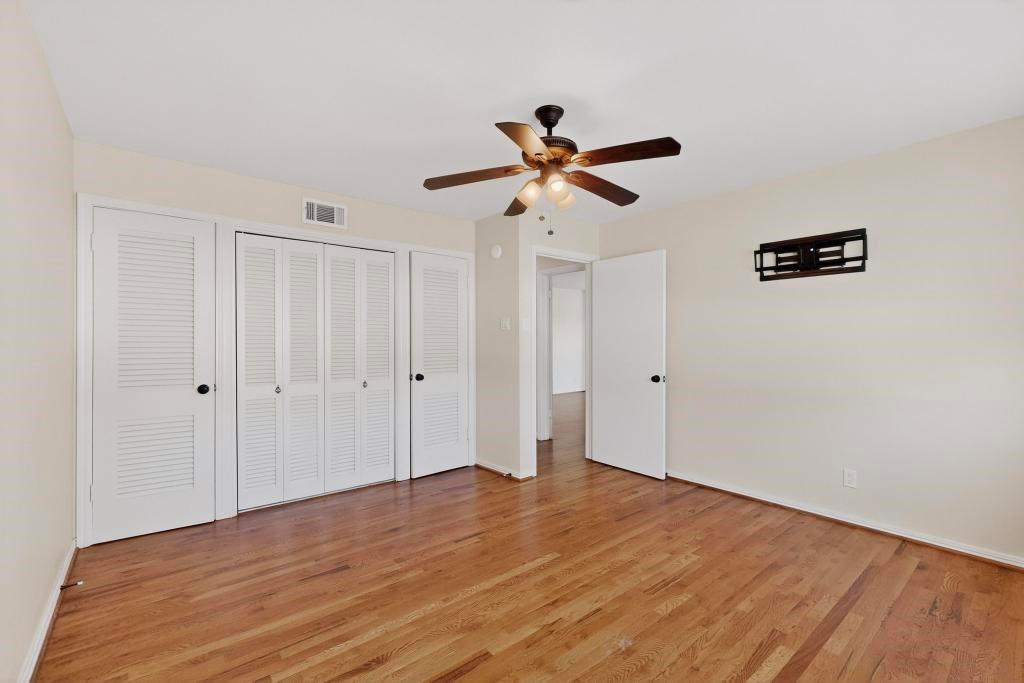 2120 Healey Drive Dallas, TX 75228 - Photo 23 of 39 a view of a big room with wooden floor and a chandelier fan