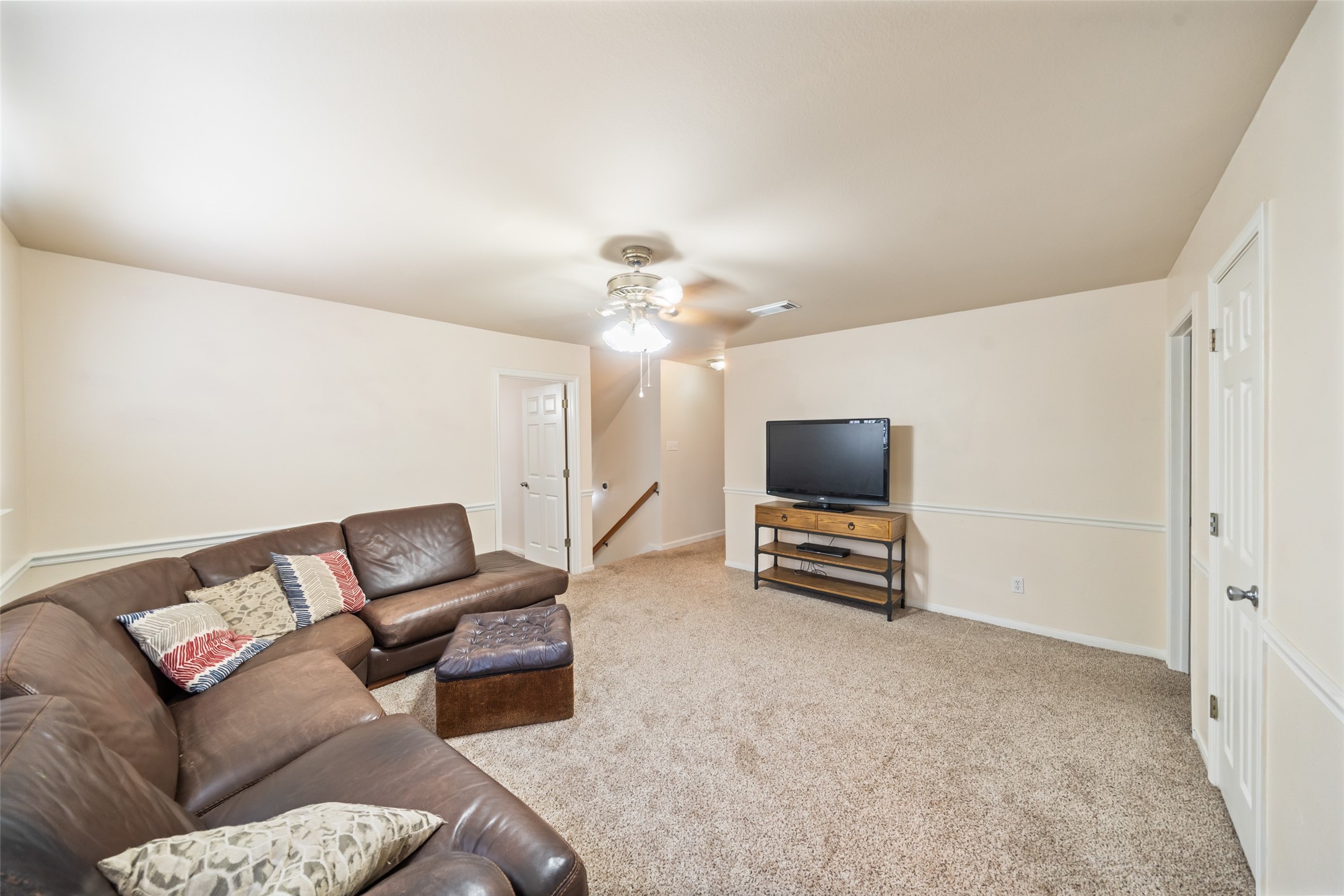 600 Hampton Hall Lane Conroe, TX 77302 - Photo 20 of 32 a living room with furniture and a flat screen tv