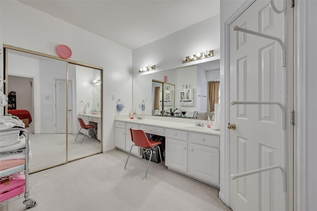 5701 Christy Lane Haltom City, TX 76137 - Photo 10 of 15 a spacious bathroom with a double vanity sink a mirror and a bathtub