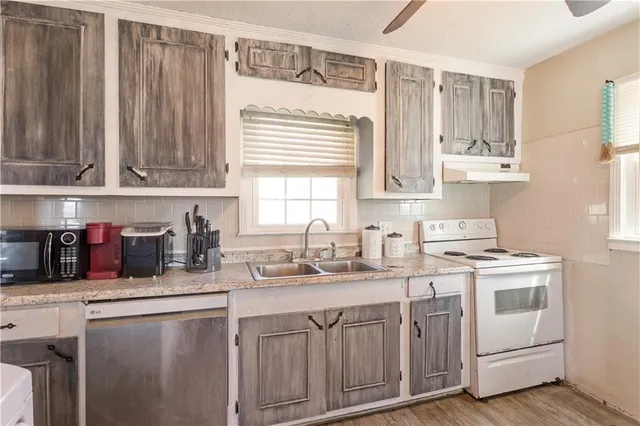 a kitchen with sink cabinets and window