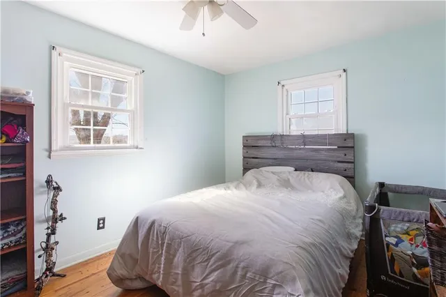 a bed sitting in a bedroom next to a window