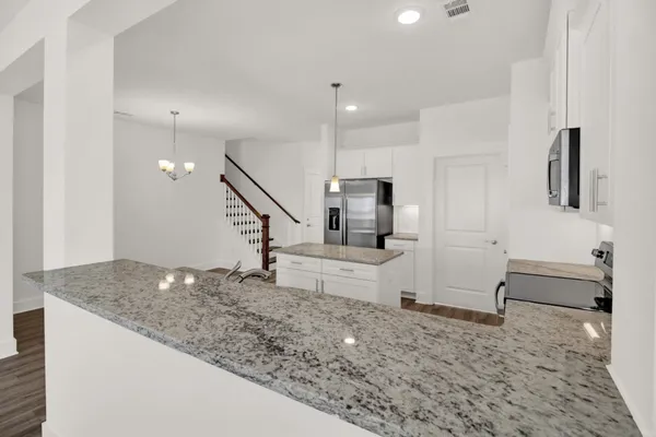 a view of entryway and kitchen