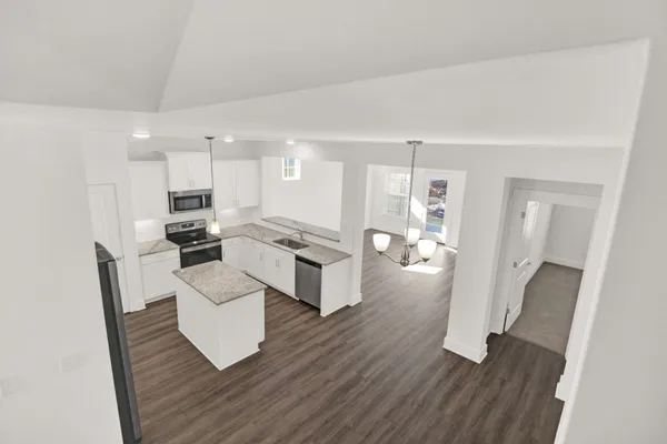 a large white kitchen with white cabinets and stainless steel appliances