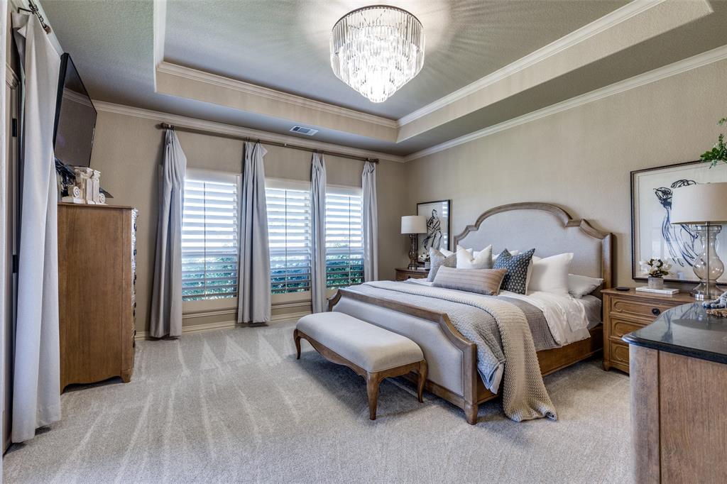 1150 Lone Star Road Bowie, TX 76230 - Photo 21 of 38 a bedroom with a bed and a chandelier