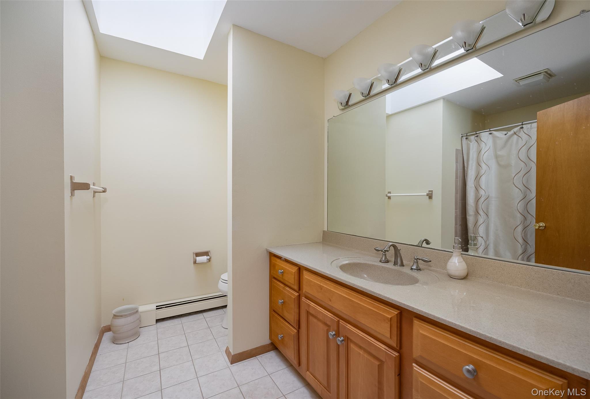 5 Chestnut Ridge Road Poughkeepsie, NY 12603 - Photo 21 of 39 a bathroom with a double vanity sink and mirror
