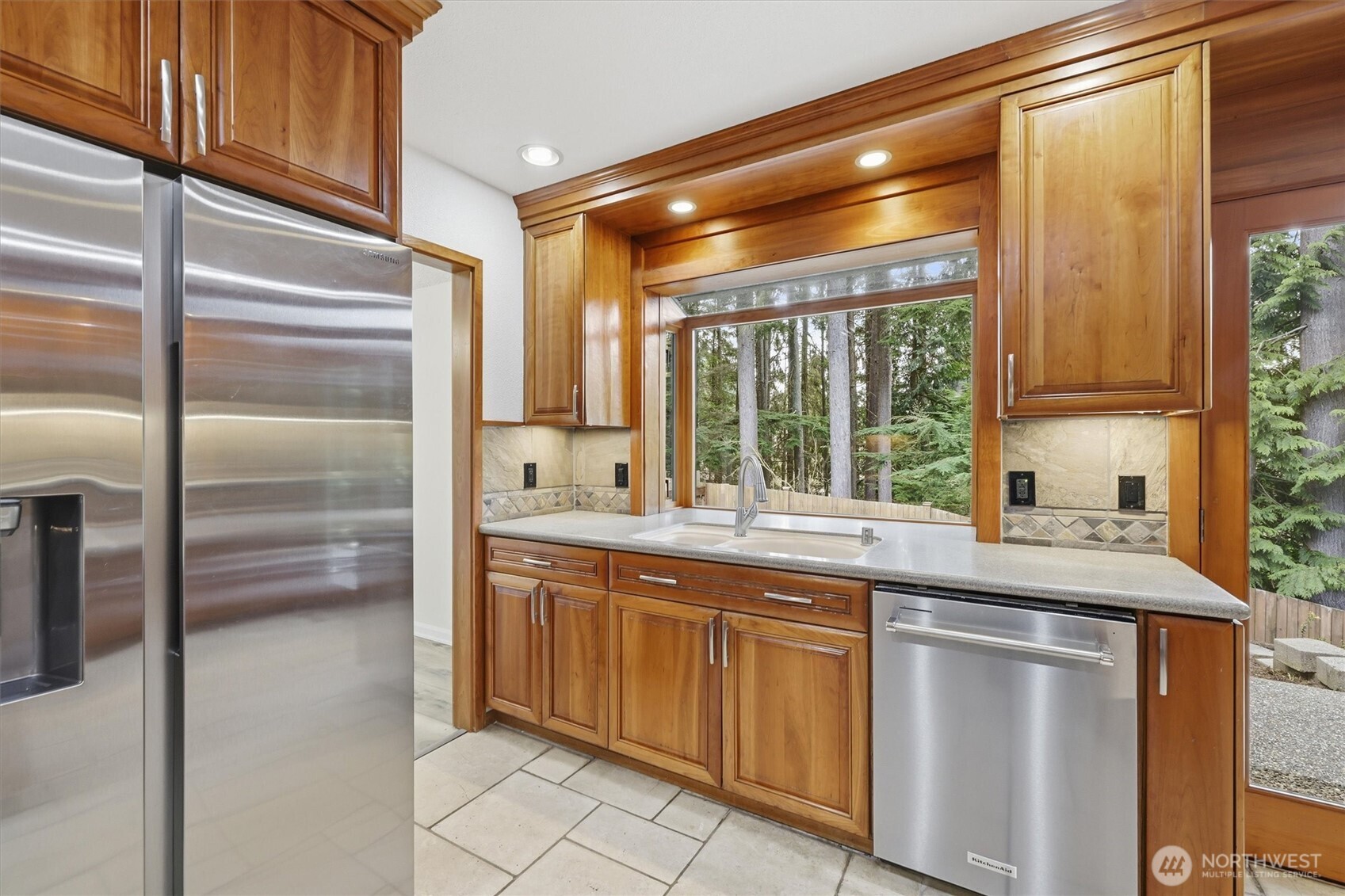 14312 63rd Avenue West Edmonds, WA 98026 - Photo 13 of 40 a kitchen with stainless steel appliances granite countertop a sink and a refrigerator