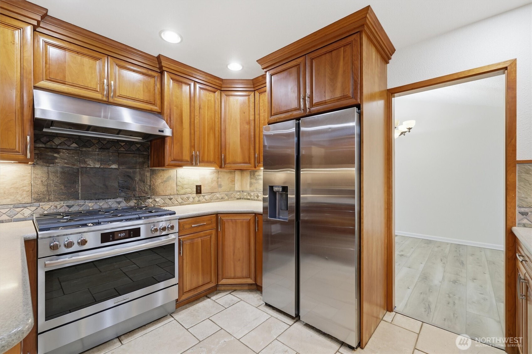 14312 63rd Avenue West Edmonds, WA 98026 - Photo 14 of 40 a kitchen with granite countertop a refrigerator stove and cabinets
