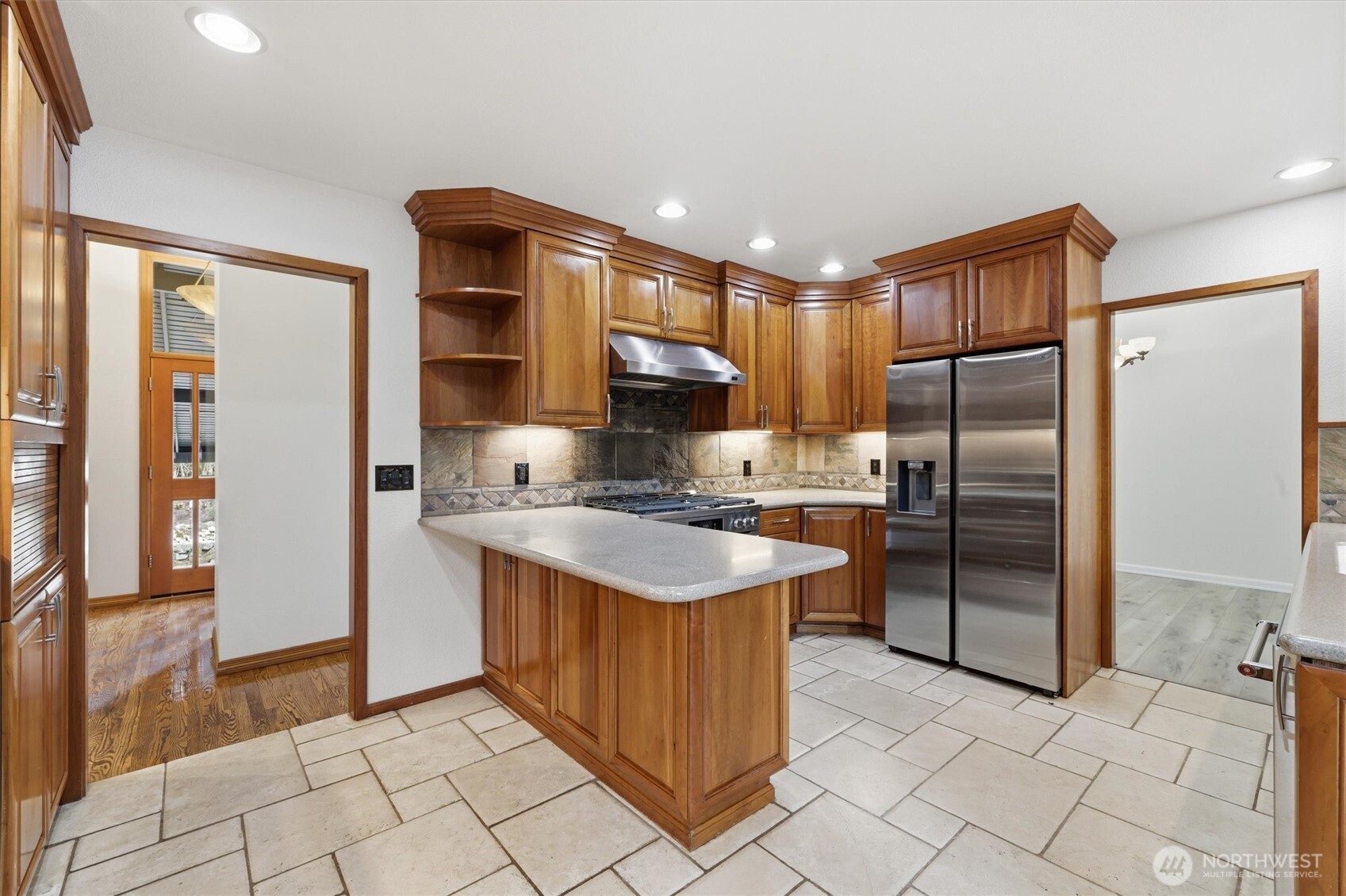 14312 63rd Avenue West Edmonds, WA 98026 - Photo 16 of 40 a kitchen with stainless steel appliances granite countertop a stove a refrigerator and a sink