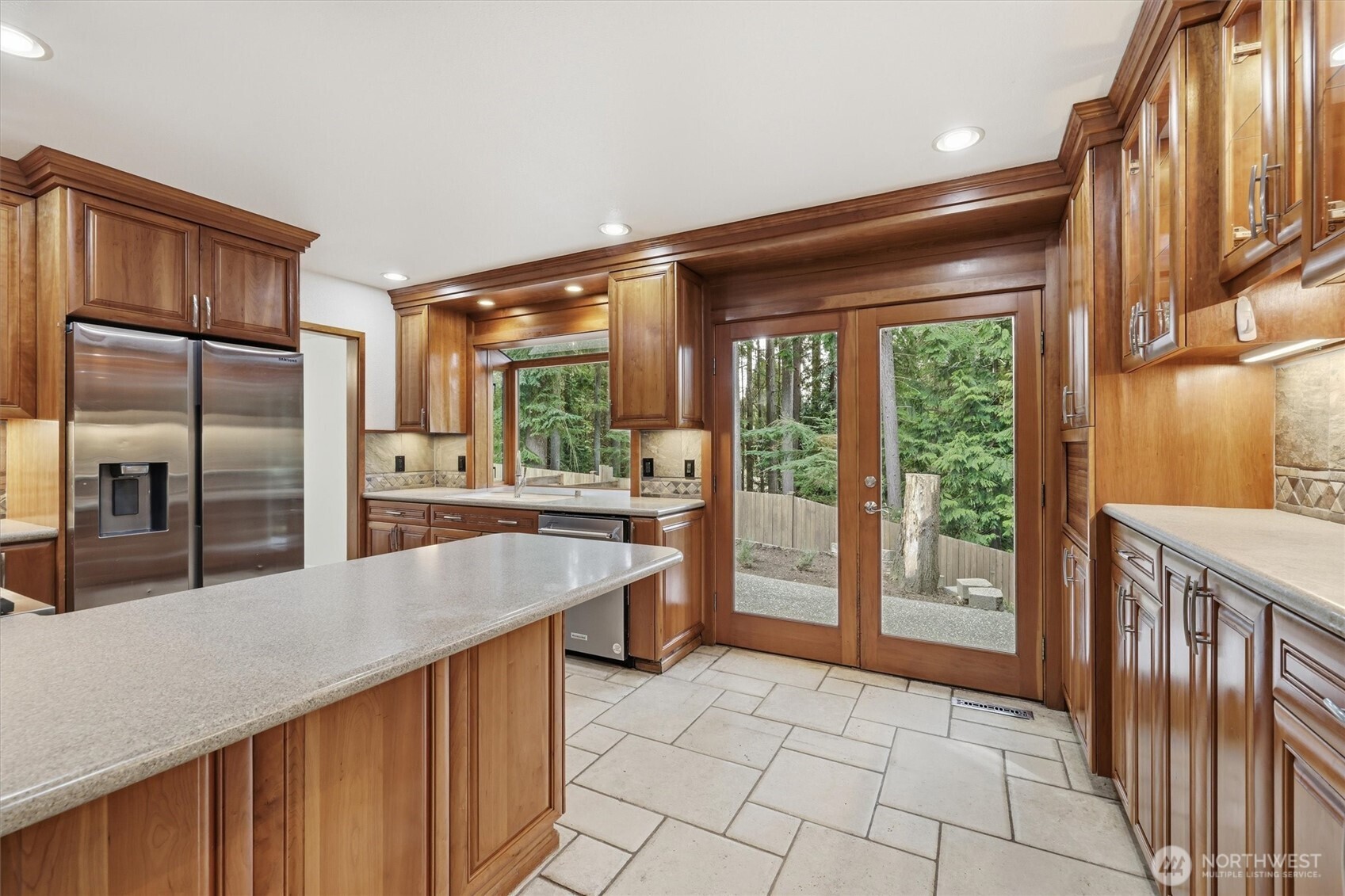 14312 63rd Avenue West Edmonds, WA 98026 - Photo 17 of 40 a dining hall with stainless steel appliances granite countertop a refrigerator a sink and wooden cabinets