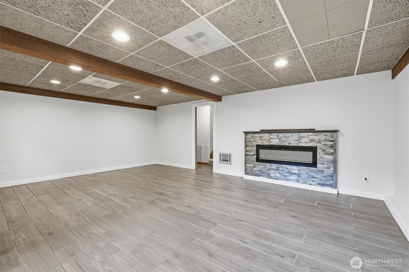 14312 63rd Avenue West Edmonds, WA 98026 - Photo 21 of 40 a view of an empty room with wooden floor and a fireplace