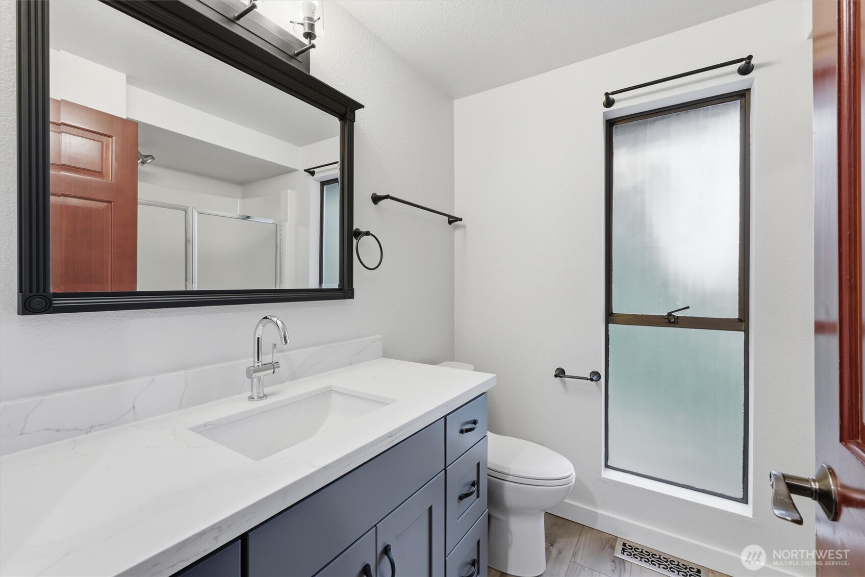 14312 63rd Avenue West Edmonds, WA 98026 - Photo 25 of 40 a bathroom with a toilet a sink a vanity and mirror