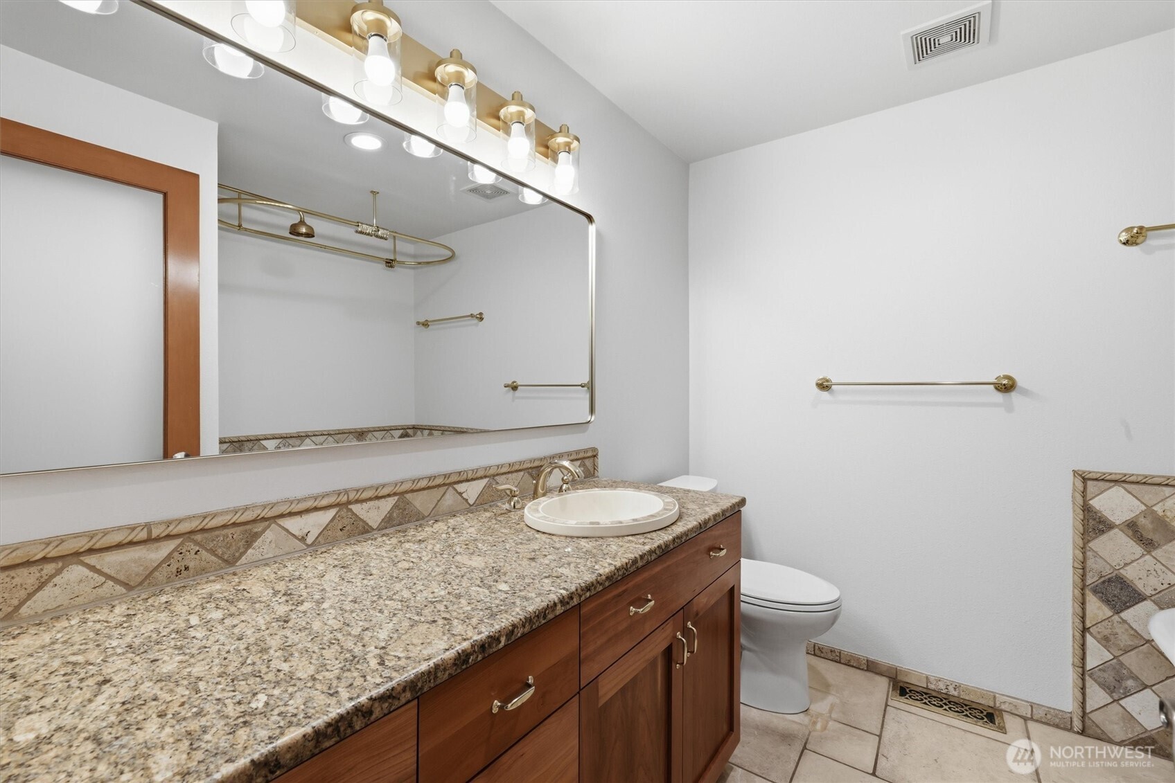 14312 63rd Avenue West Edmonds, WA 98026 - Photo 26 of 40 a bathroom with a granite countertop sink a toilet and a mirror