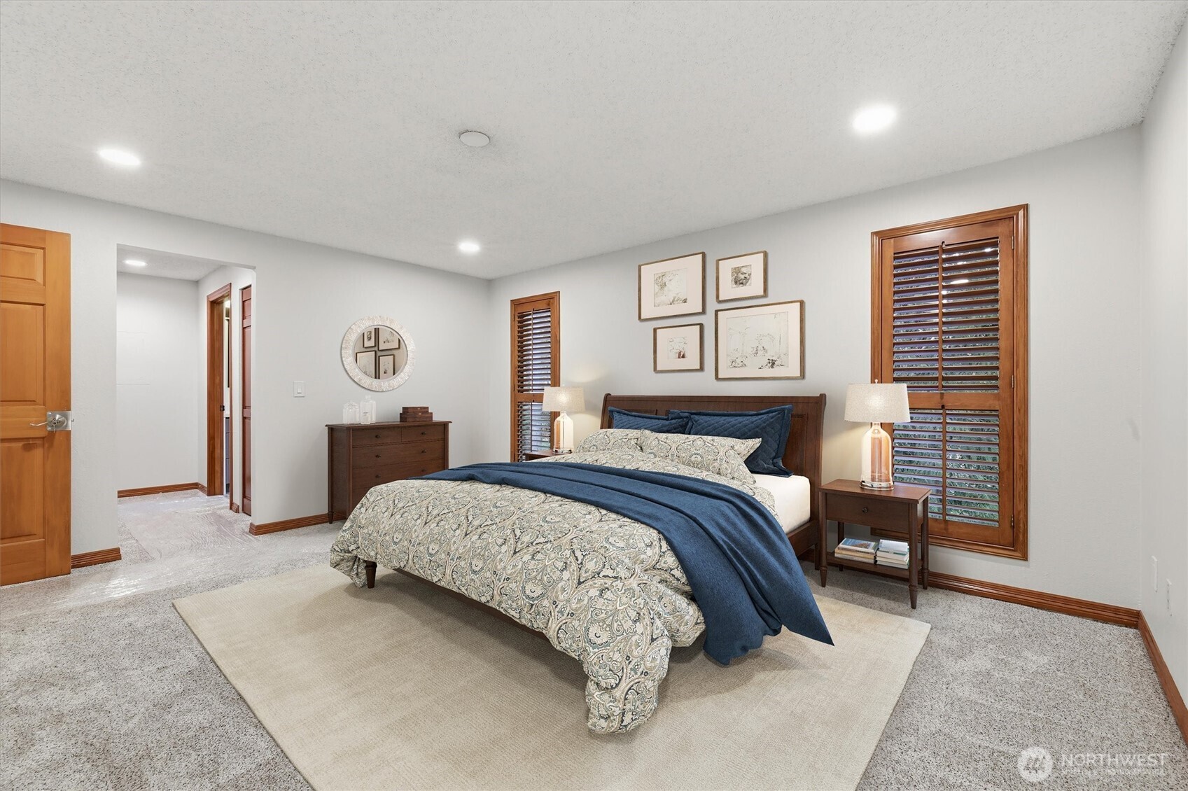 14312 63rd Avenue West Edmonds, WA 98026 - Photo 33 of 40 a spacious bedroom with a bed and painting on the wall