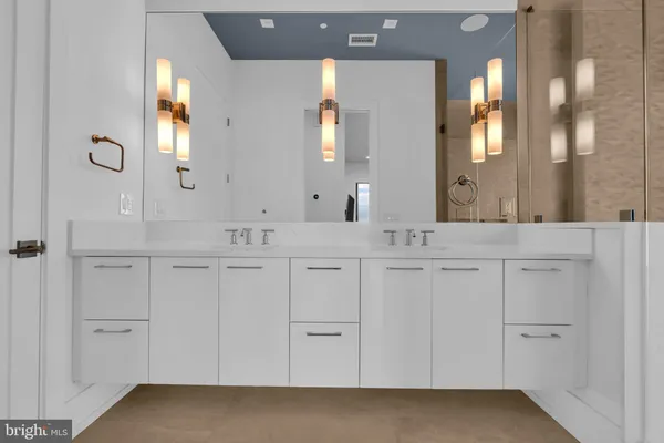 a bathroom with a double vanity sink and a mirror