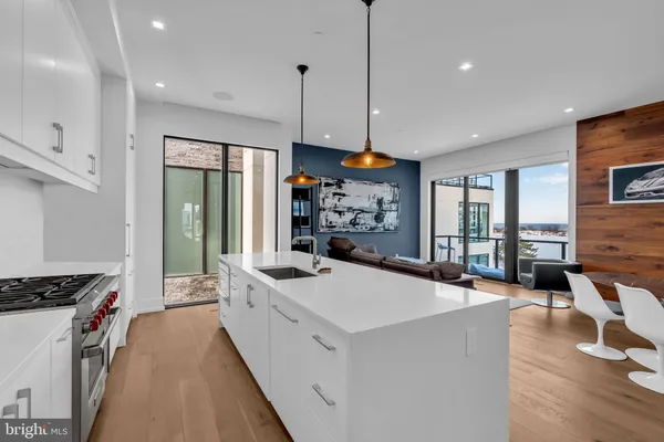 a open kitchen with stainless steel appliances granite countertop a lot of counter space and a wooden floor