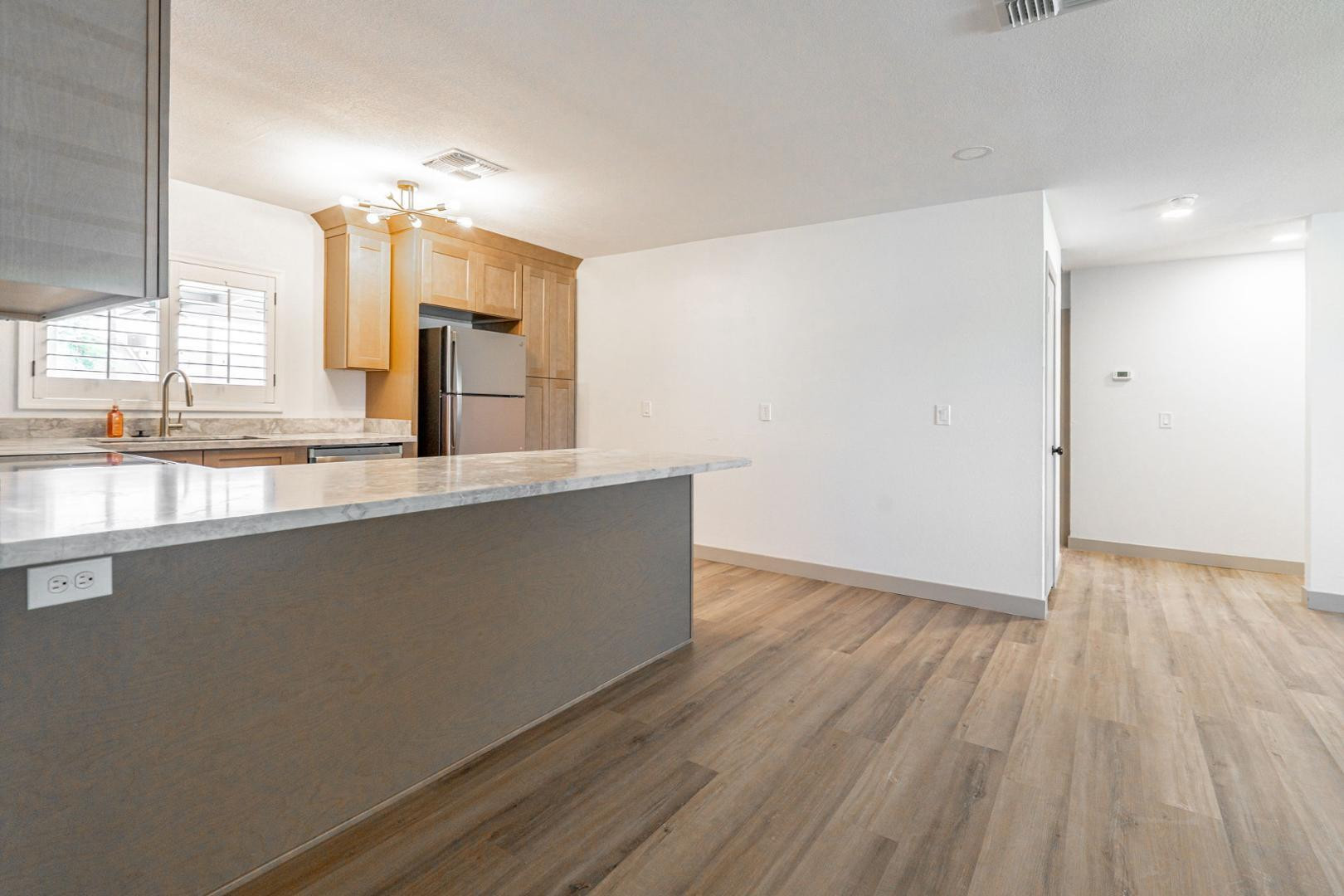 5739 West Monte Vista Road Phoenix, AZ 85035 - Photo 5 of 23 a view of a kitchen with a sink and wooden floor