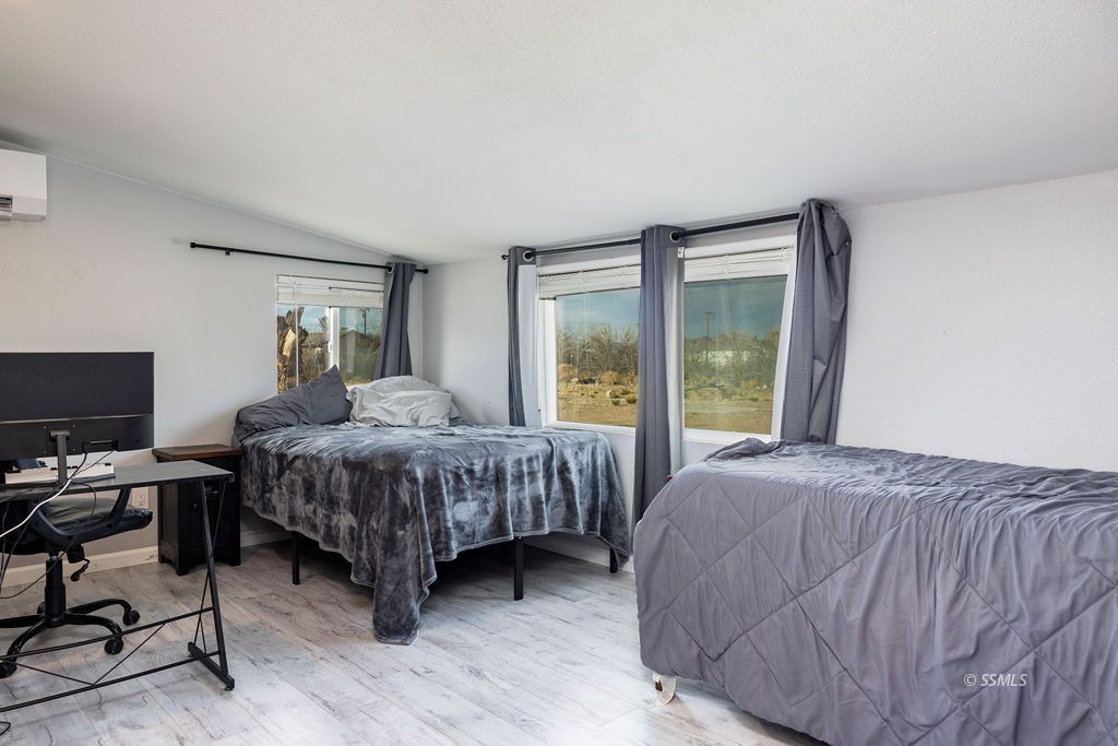 134 South Sierra View Street Ridgecrest, CA 93555 - Photo 19 of 43 a bedroom with a bed and a desk