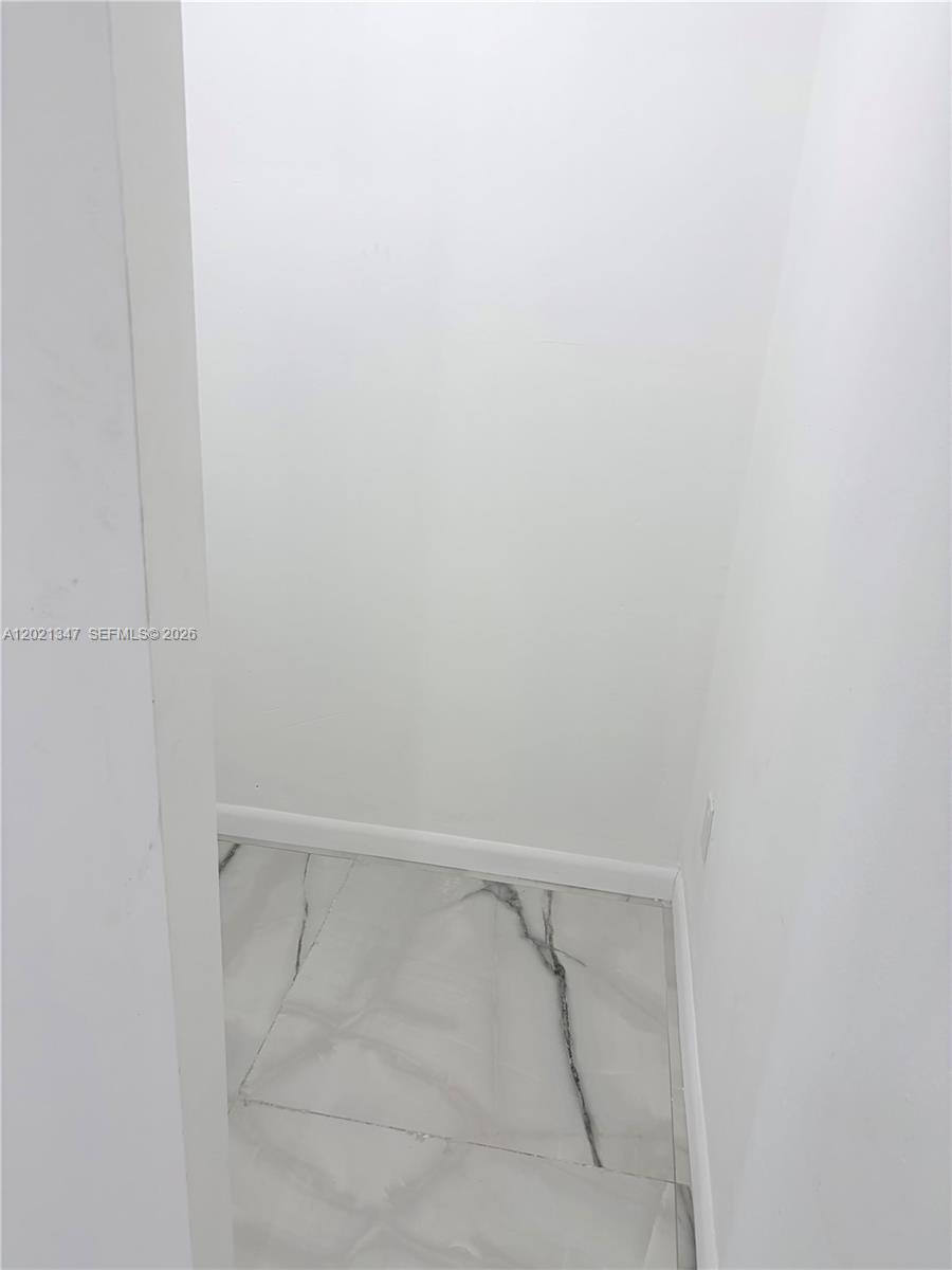 13065 Southwest 263rd Terrace, Unit 2 Homestead, FL 33032 - Photo 13 of 15 a view of an empty walk in closet