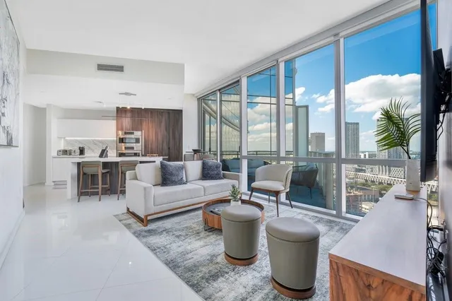 a living room with furniture and a large window