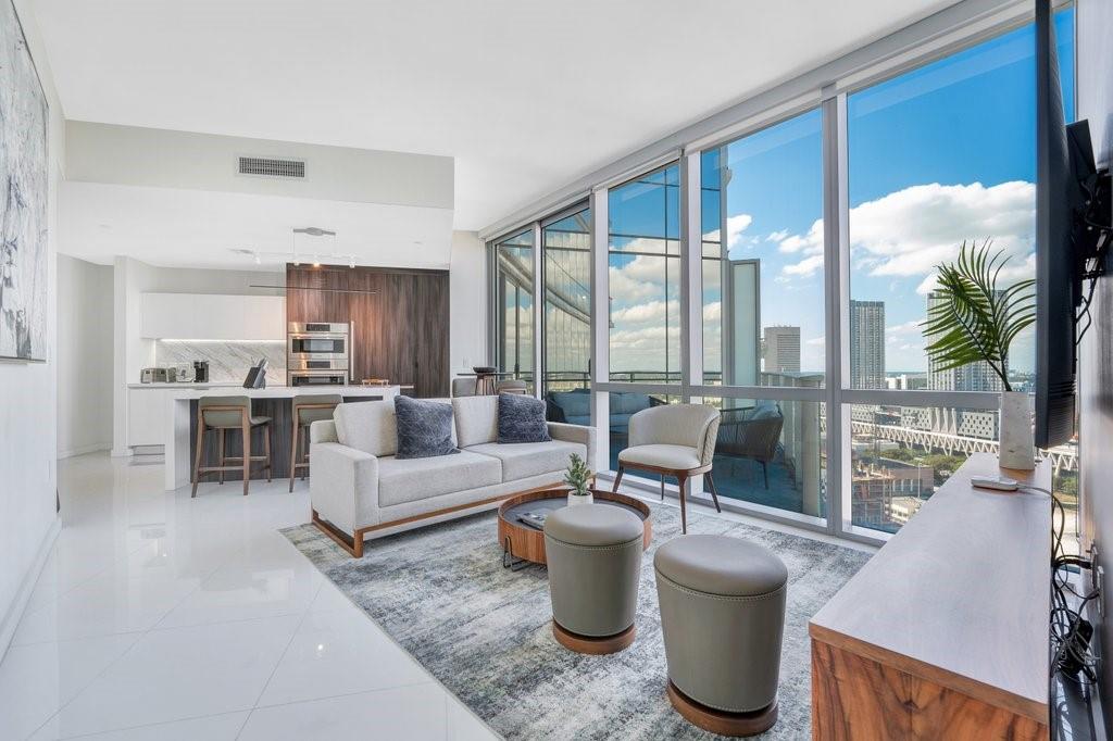 851 Northeast 1st Avenue, Unit 2202 Miami, FL 33132 - Photo 1 of 56 a living room with furniture and a large window