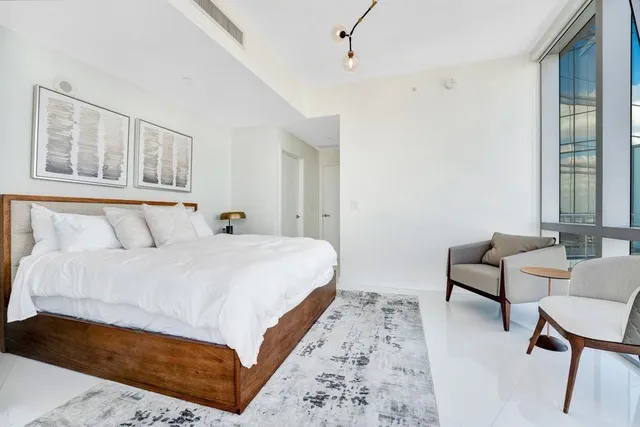 a bedroom with bed and a window