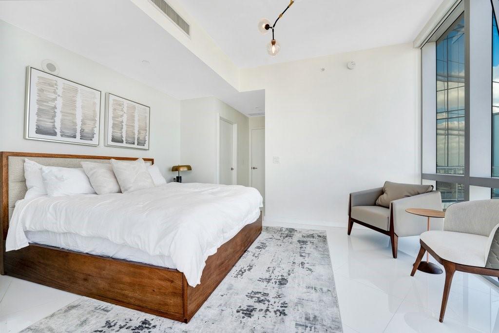 851 Northeast 1st Avenue, Unit 2202 Miami, FL 33132 - Photo 11 of 56 a bedroom with bed and a window