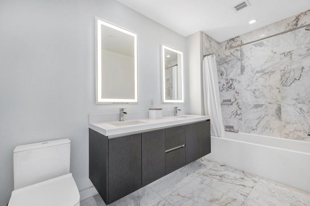 851 Northeast 1st Avenue, Unit 2202 Miami, FL 33132 - Photo 14 of 56 a bathroom with a sink and a toilet